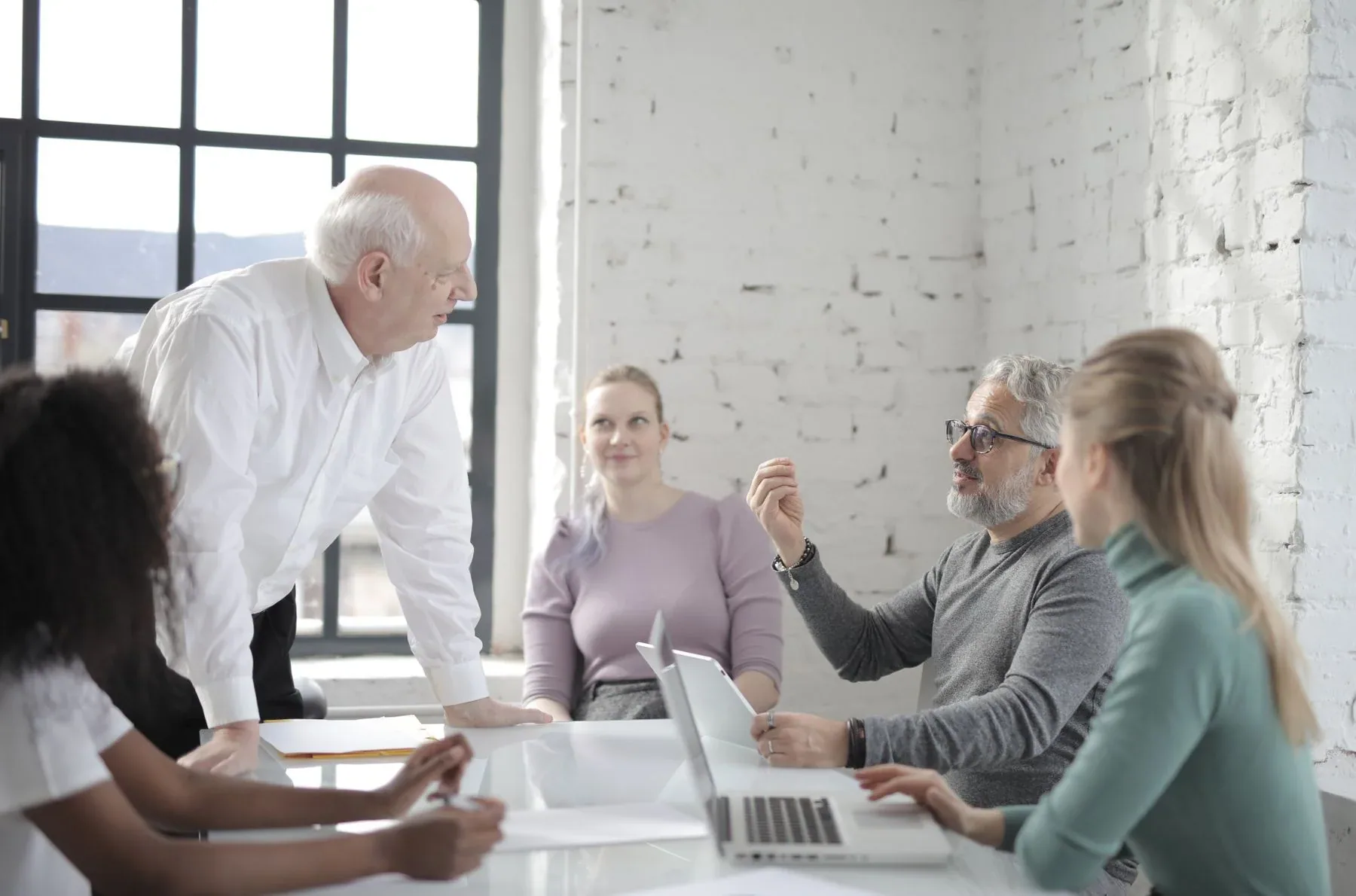 A group of professionals sharing perspectives around a meeting table